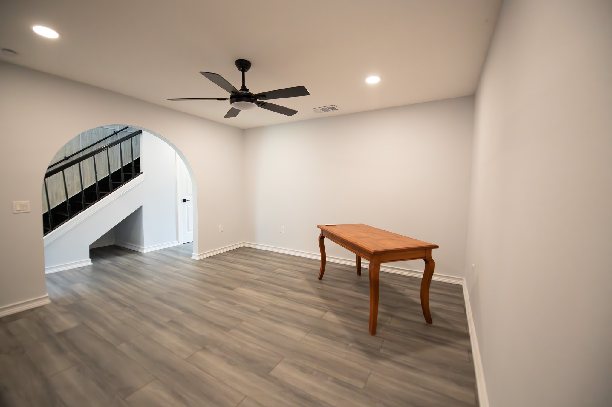 17106 Spring Creek Forest Drive Spring, TX 77379 - Photo 7 of 50 a view of an empty room with wooden floor and a ceiling fan