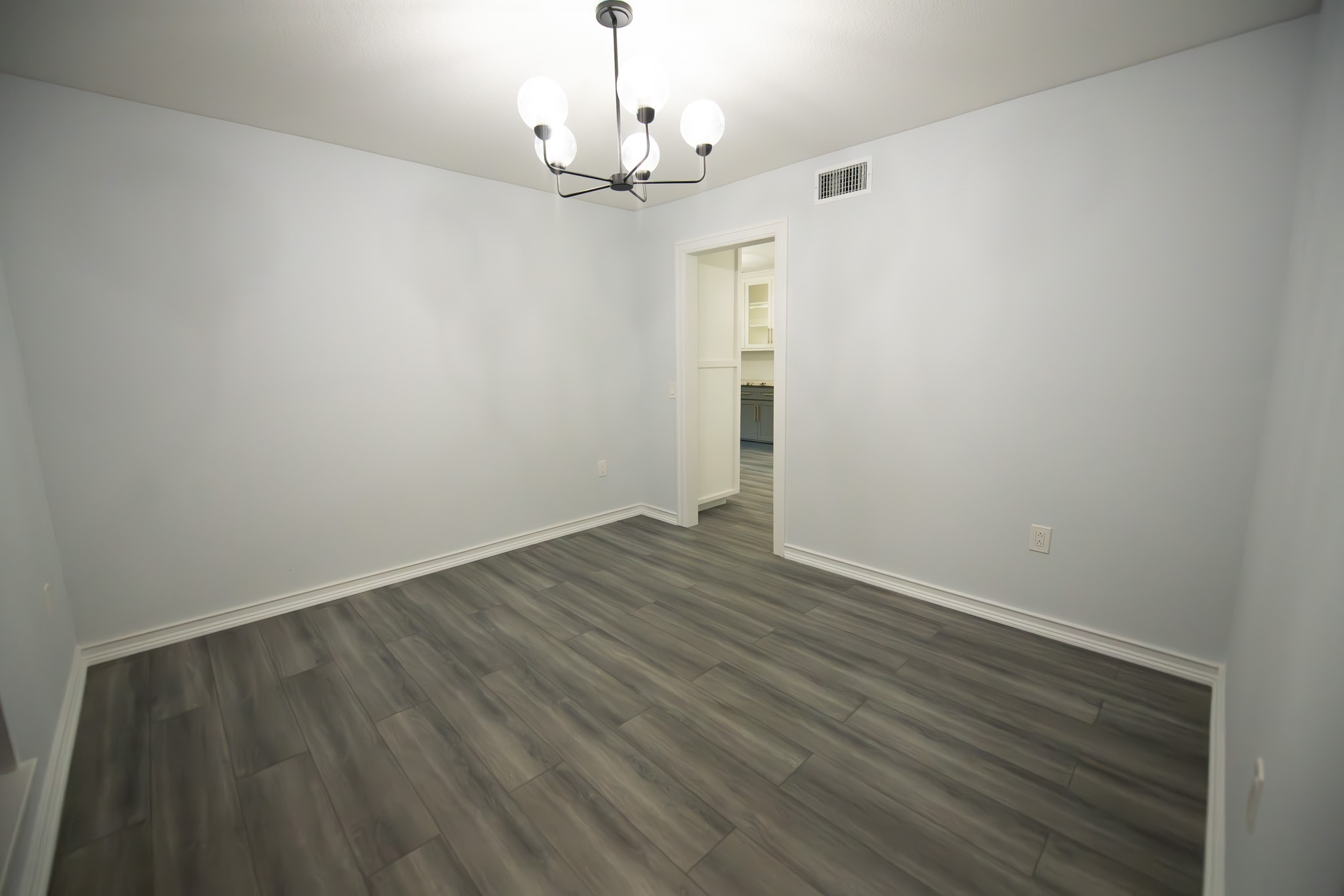 17106 Spring Creek Forest Drive Spring, TX 77379 - Photo 8 of 50 a view of empty room with wooden floor chandelier and window
