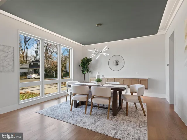 a kitchen with stainless steel appliances kitchen island granite countertop a kitchen island a stove a table and chairs