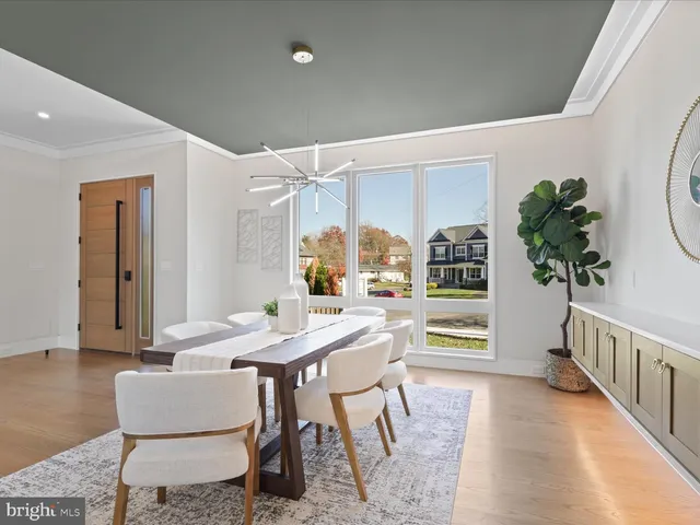 a living room with furniture a fireplace and a large window
