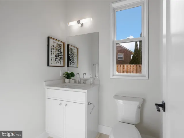 a living room with furniture kitchen view and a large window