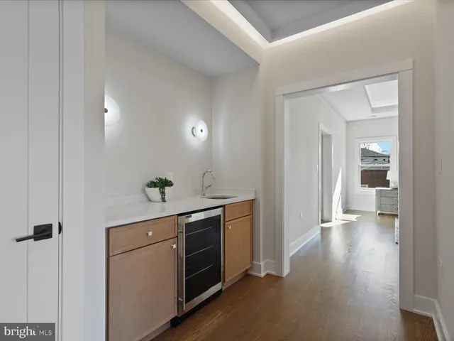 a large white room with a large window and a sink