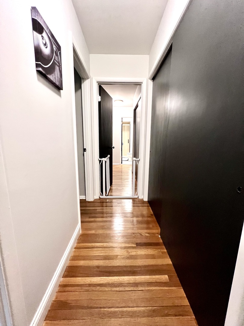9128 North 1900 East Road Bloomington, IL 61705 - Photo 19 of 36 a view of a hallway with wooden floor and staircase