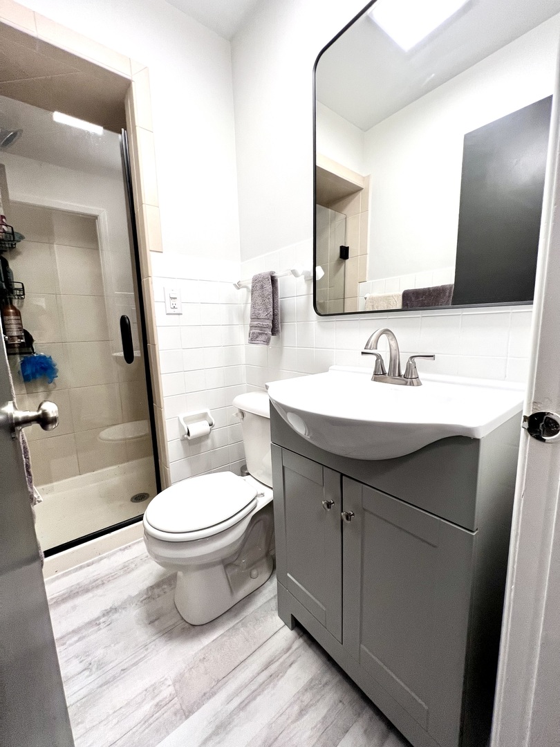 9128 North 1900 East Road Bloomington, IL 61705 - Photo 22 of 36 a bathroom with a sink toilet a mirror and vanity