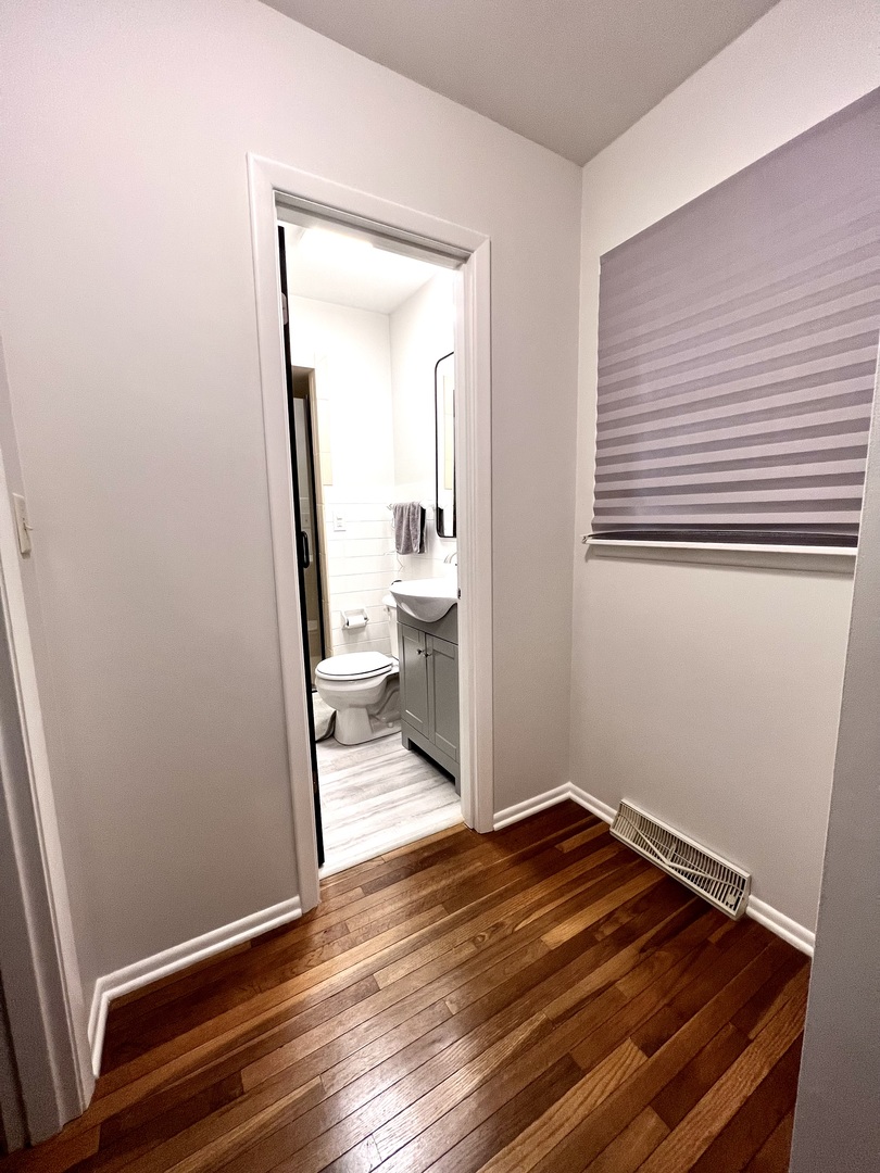 9128 North 1900 East Road Bloomington, IL 61705 - Photo 23 of 36 a view of a room with wooden floor and bathroom