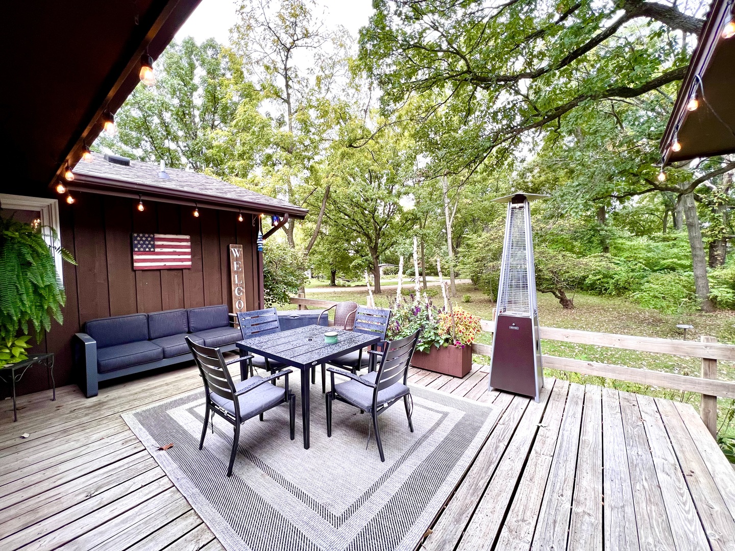 9128 North 1900 East Road Bloomington, IL 61705 - Photo 3 of 36 a view of a patio with table and chairs and wooden floor