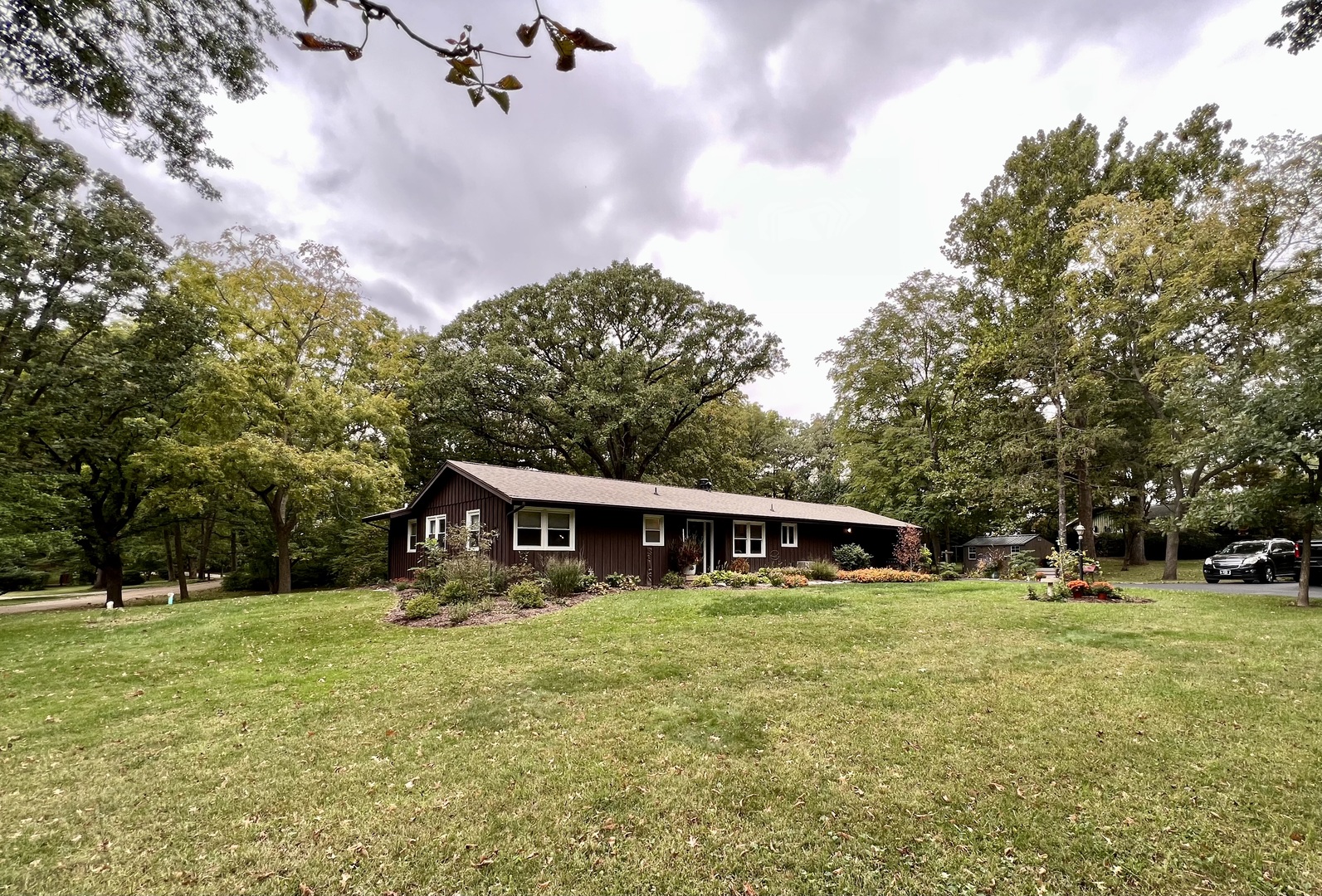 9128 North 1900 East Road Bloomington, IL 61705 - Photo 35 of 36 a view of a house with yard and trees in the background