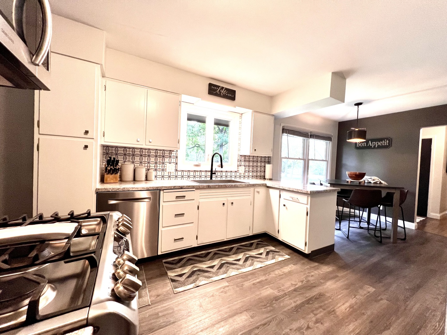 9128 North 1900 East Road Bloomington, IL 61705 - Photo 9 of 36 a kitchen that has a lot of cabinets in it and wooden floors