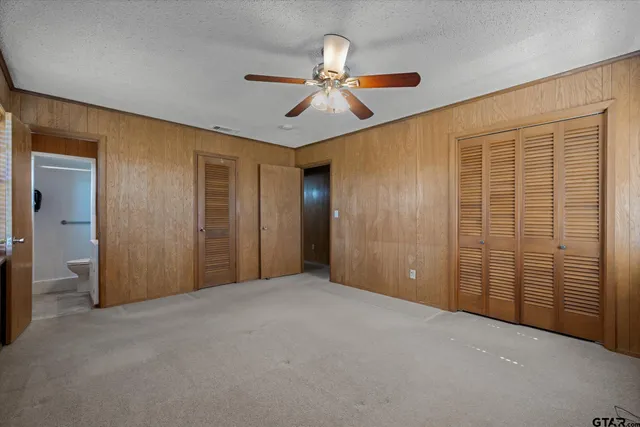 a view of a hallway with a ceiling fan