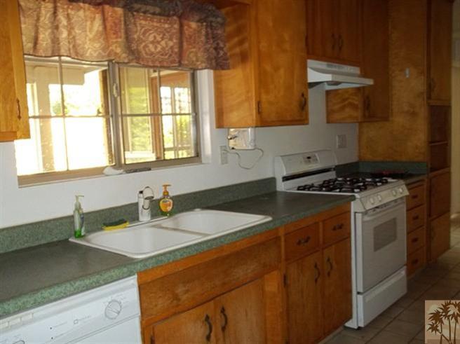 70130 Chappel Road Rancho Mirage, CA 92270 - Photo 2 of 20 a kitchen with stainless steel appliances granite countertop a sink stove and cabinets