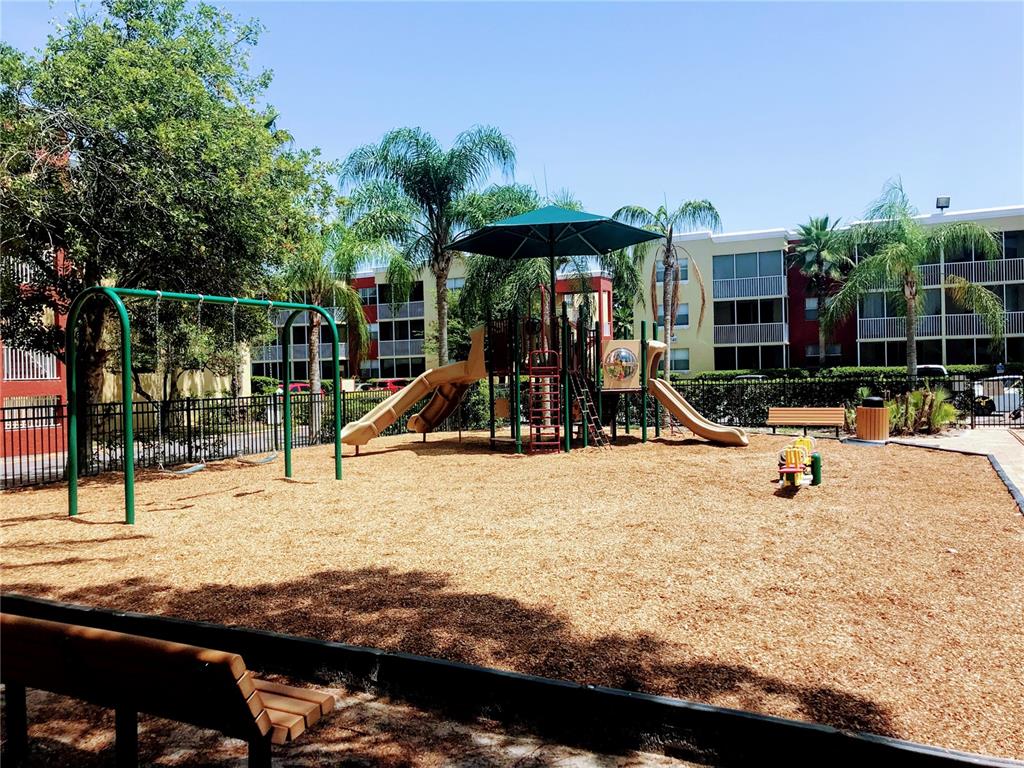 2630 Coconut Bay Lane, Unit 618 (61I) Sarasota, FL 34237 - Photo 26 of 29 a view of a park with swings