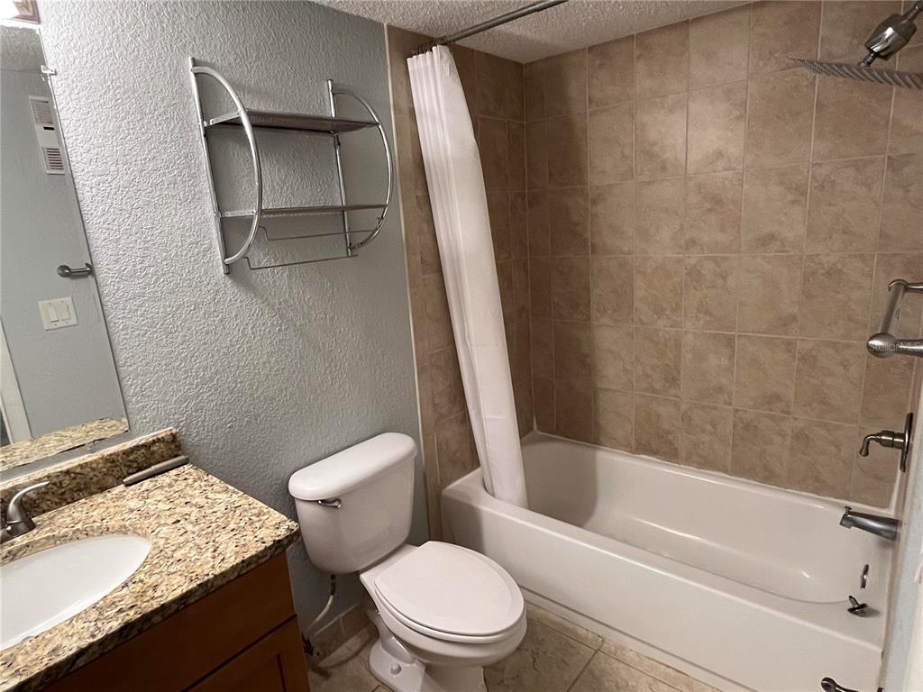 2630 Coconut Bay Lane, Unit 618 (61I) Sarasota, FL 34237 - Photo 10 of 29 a white toilet sitting next to a bath tub