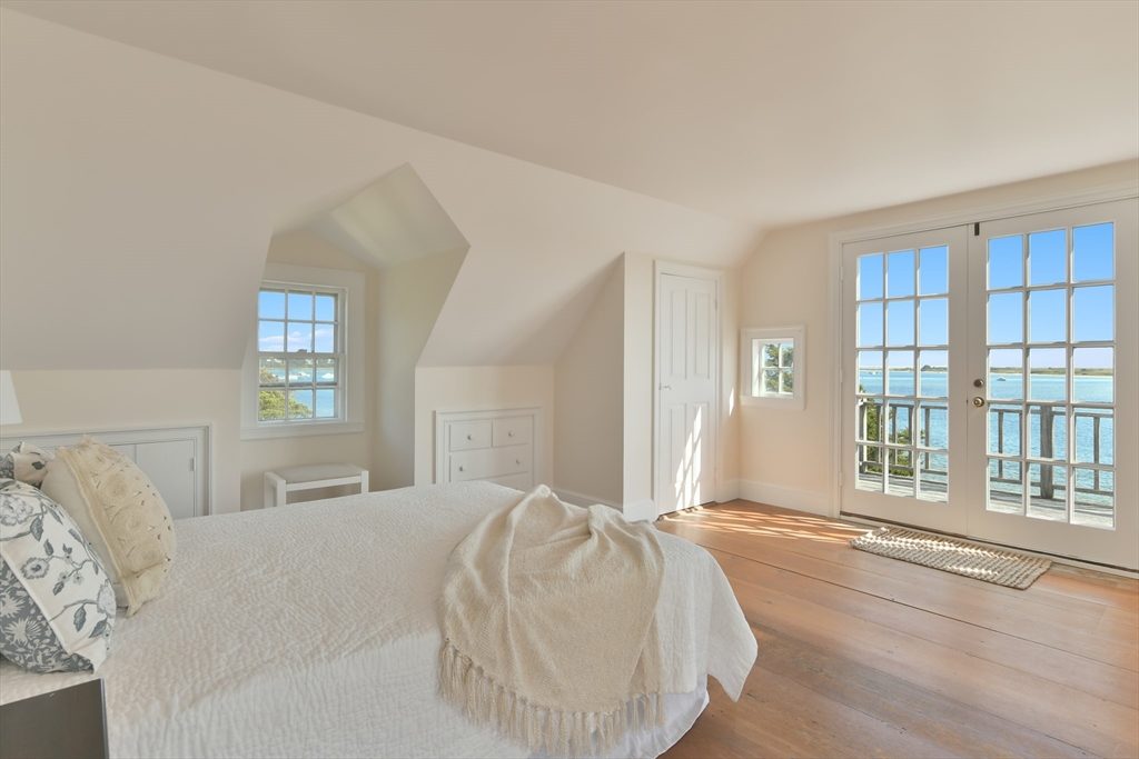 70 Sears Point Chatham, MA 02633 - Photo 22 of 42 a bedroom with a bed and a large window