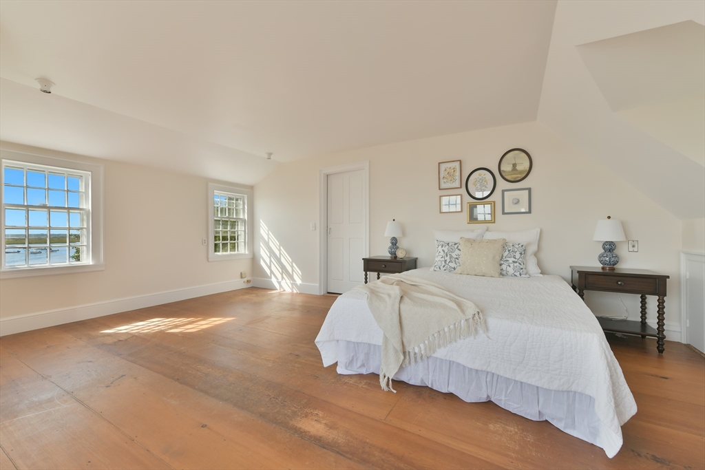 70 Sears Point Chatham, MA 02633 - Photo 25 of 42 a bedroom with a bed and a table