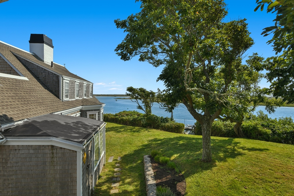 70 Sears Point Chatham, MA 02633 - Photo 32 of 42 a backyard of a house with lots of green space