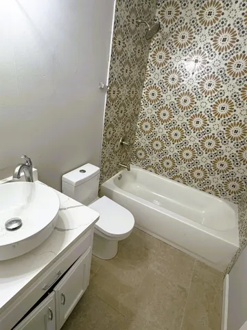 a bathroom with a sink a toilet and bathtub