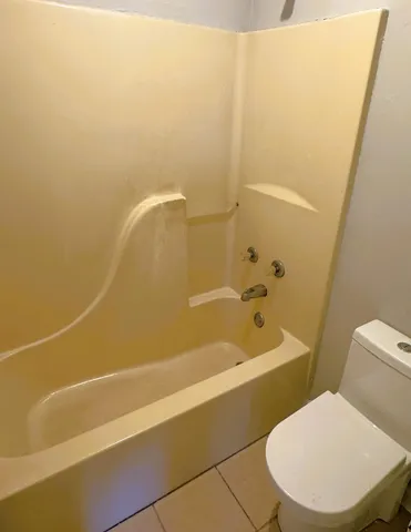 a bathroom with a toilet and a bathtub