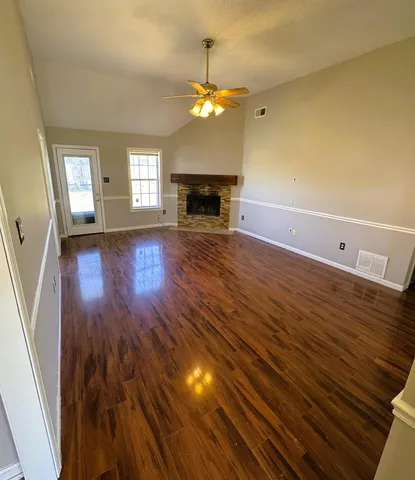 a view of a room with wooden floor and fireplace