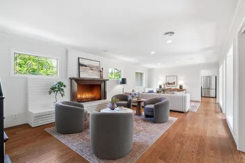 a living room with furniture a window and a fireplace
