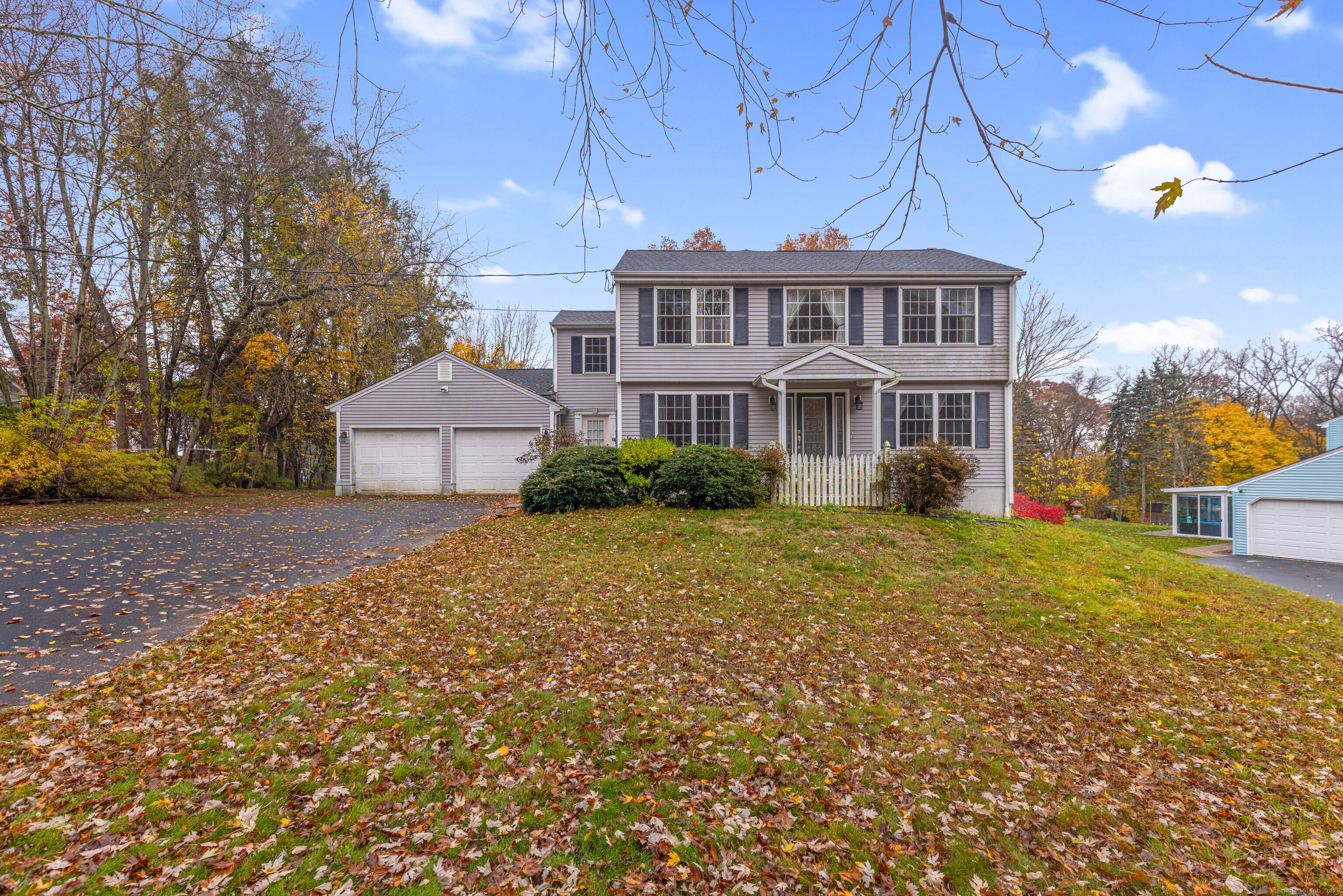 a view of a house with a yard and sitting area