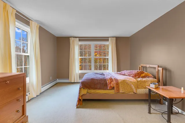 a bed sitting in a bedroom next to a window