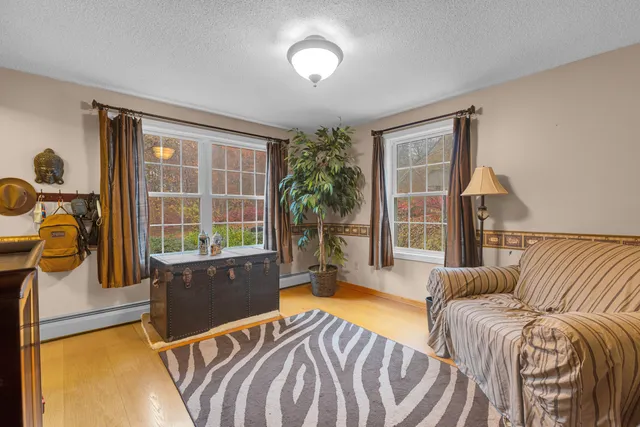 a spacious bedroom with a bed and glass window