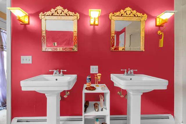 a bathroom with a sink mirror and vanity