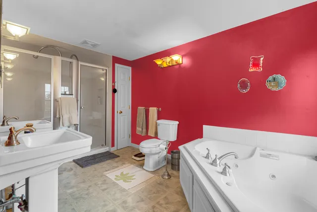 a bathroom with a sink mirror vanity and toilet