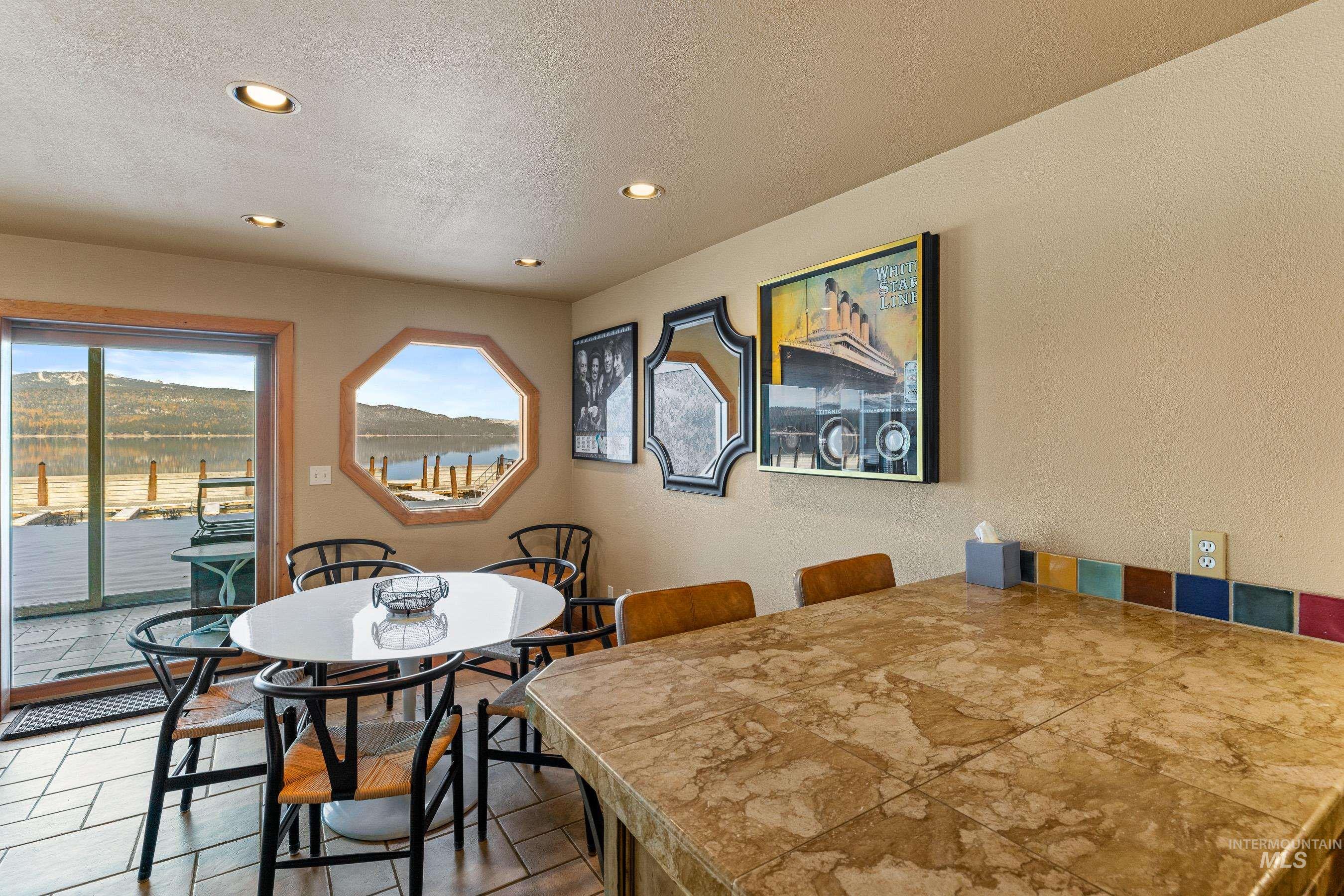 101 East Lake Street, Unit C15 McCall, ID 83638 - Photo 16 of 48 Dining space with recessed lighting, a textured wall, a textured ceiling, and a water view