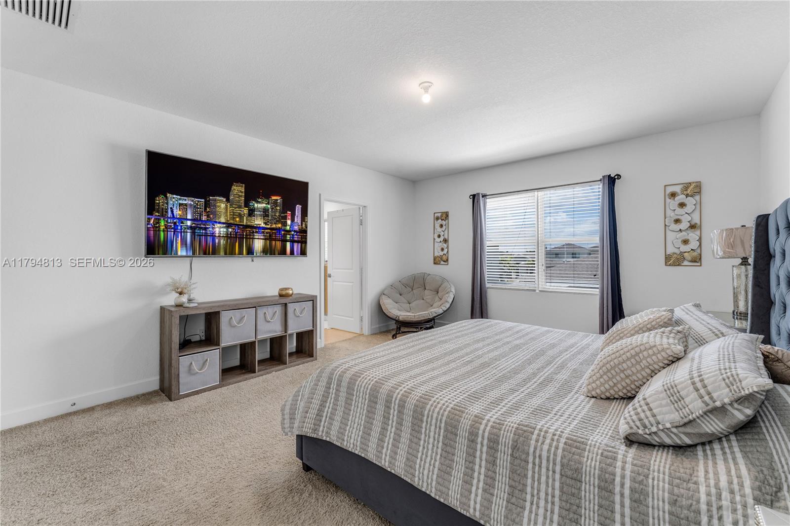 13225 Southwest 272nd Street Homestead, FL 33032 - Photo 14 of 44 a bedroom with a bed and a flat tv screen on a dresser