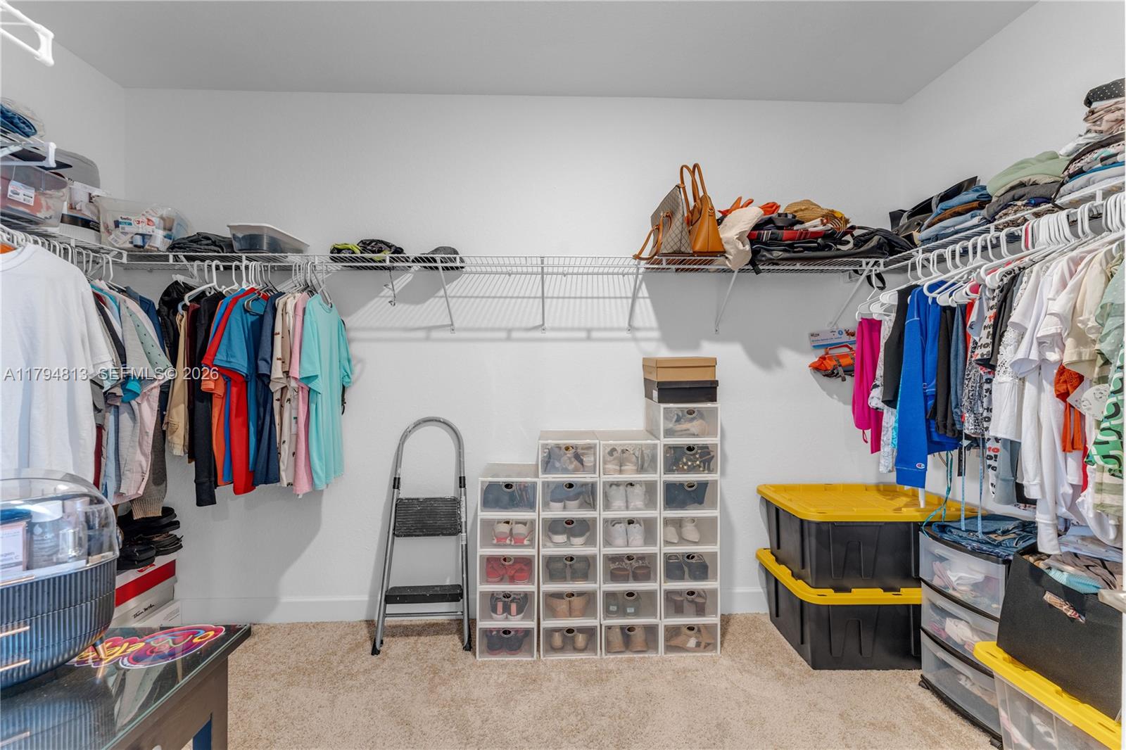 13225 Southwest 272nd Street Homestead, FL 33032 - Photo 17 of 44 a view of walk in closet with clothes and shoes