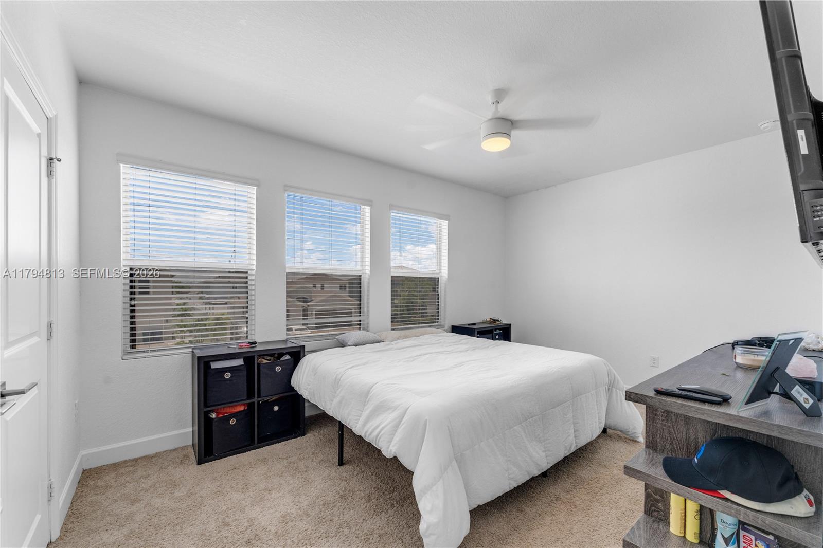 13225 Southwest 272nd Street Homestead, FL 33032 - Photo 18 of 44 a bedroom with a bed and a table in it