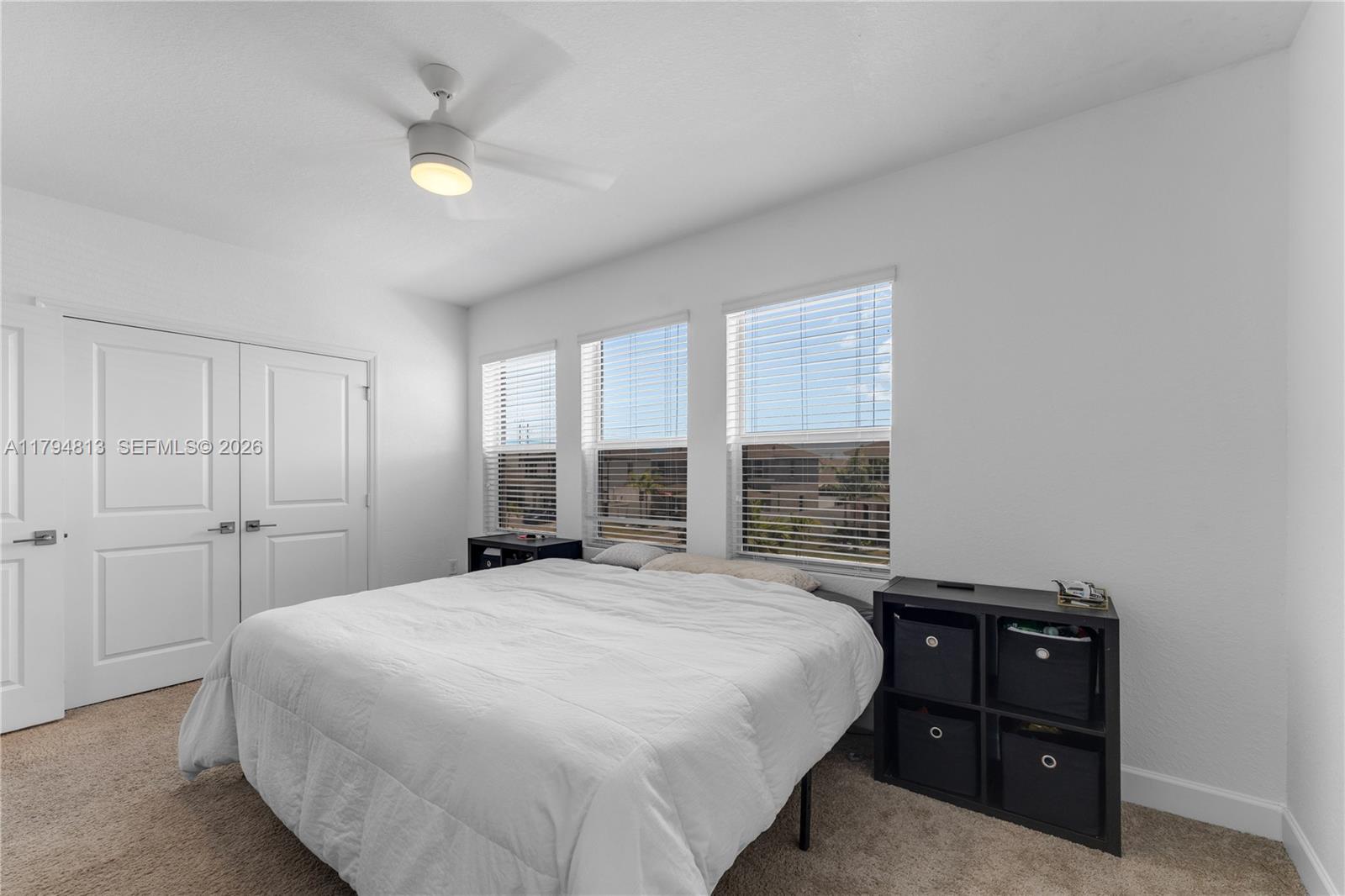 13225 Southwest 272nd Street Homestead, FL 33032 - Photo 19 of 44 a bedroom with a bed and a night stand