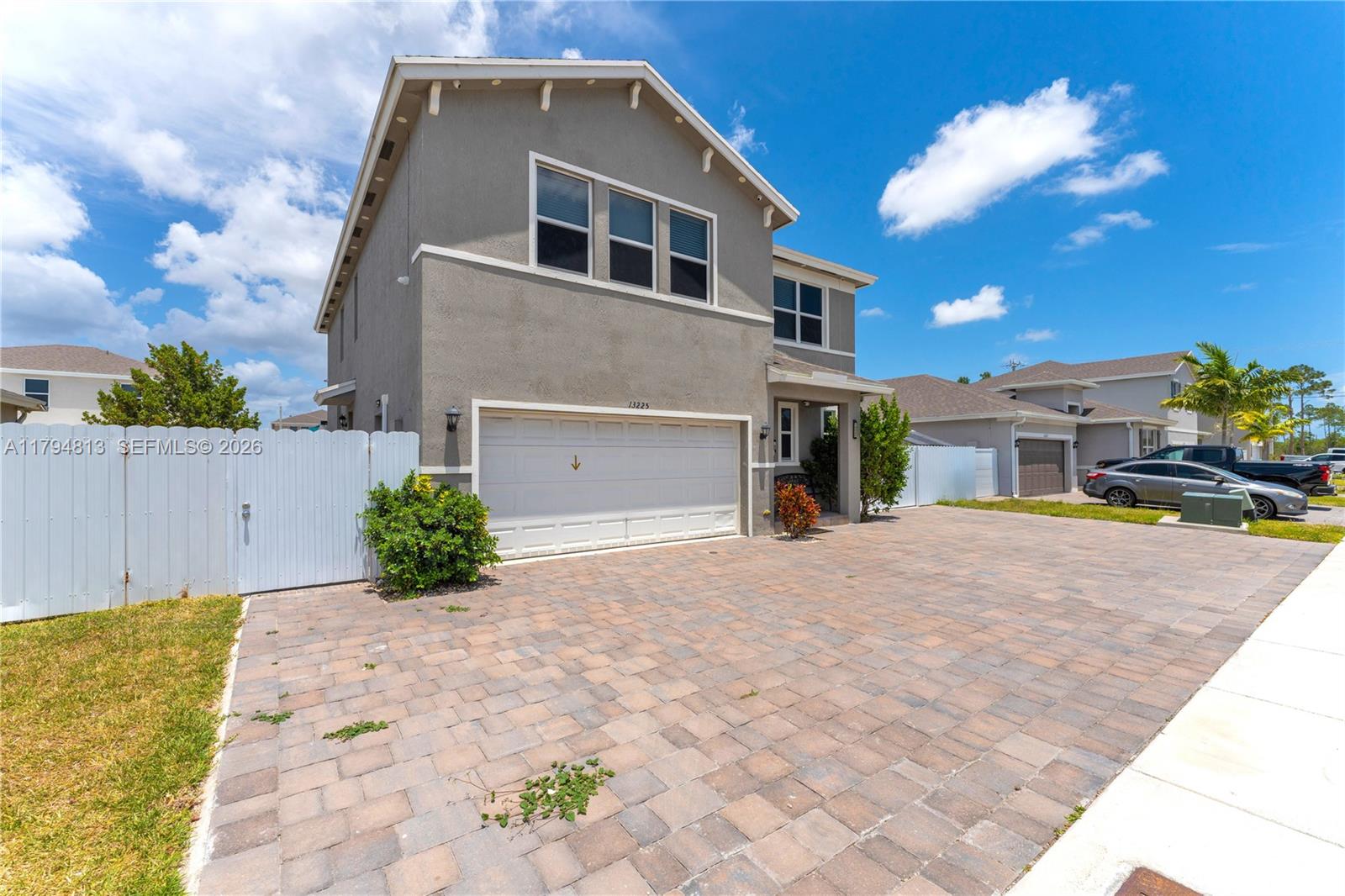 13225 Southwest 272nd Street Homestead, FL 33032 - Photo 2 of 44 a front view of a house with a yard and garage
