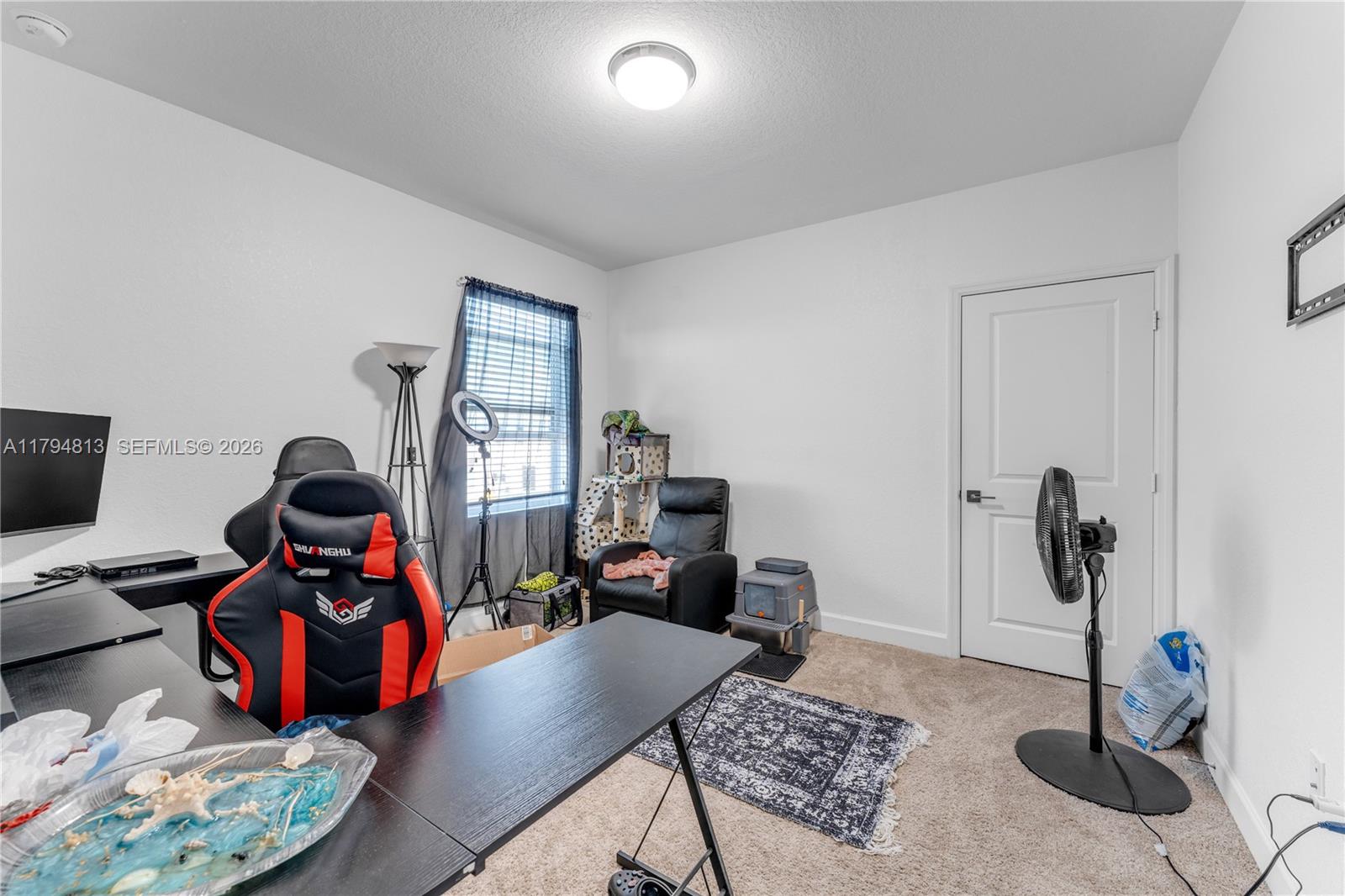 13225 Southwest 272nd Street Homestead, FL 33032 - Photo 21 of 44 a living room with furniture and a mirror