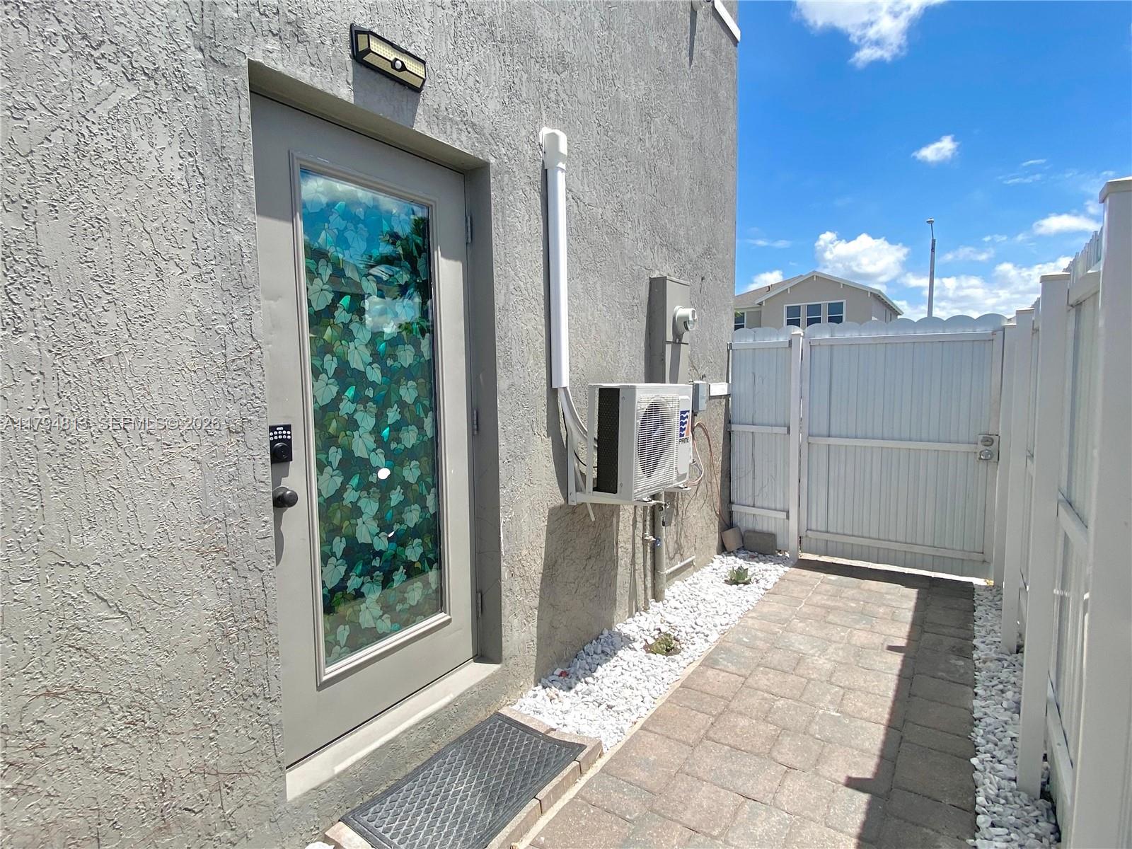 13225 Southwest 272nd Street Homestead, FL 33032 - Photo 25 of 44 a backyard of a house with table and chairs