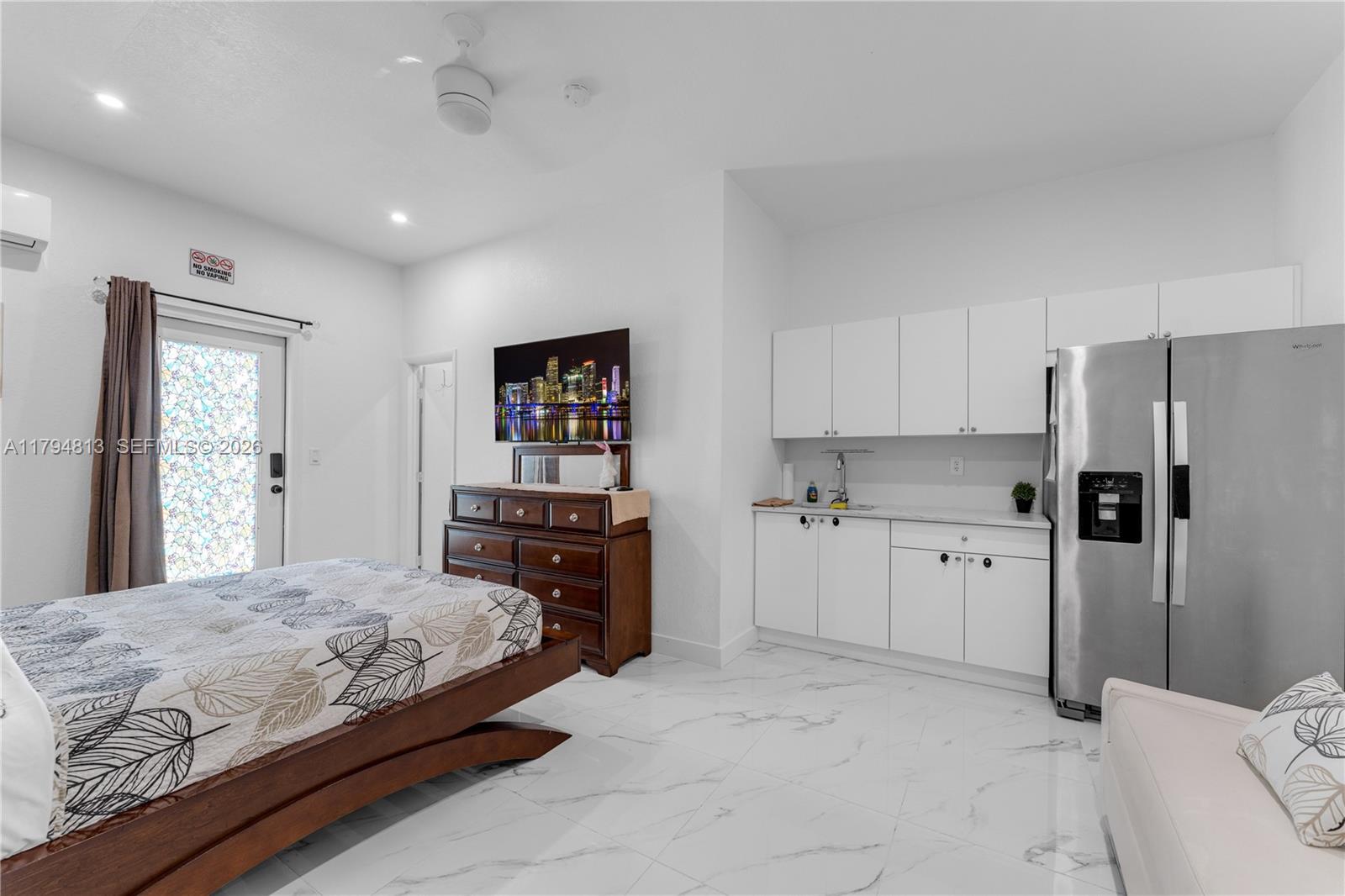 13225 Southwest 272nd Street Homestead, FL 33032 - Photo 27 of 44 a bedroom with a bed and a refrigerator