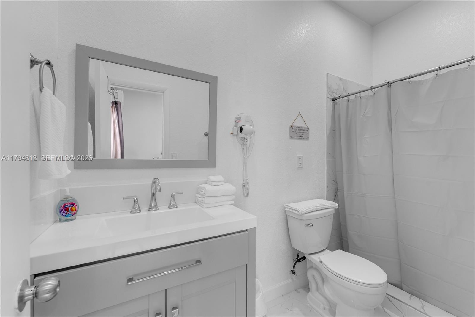 13225 Southwest 272nd Street Homestead, FL 33032 - Photo 28 of 44 a bathroom with a sink a toilet and a mirror