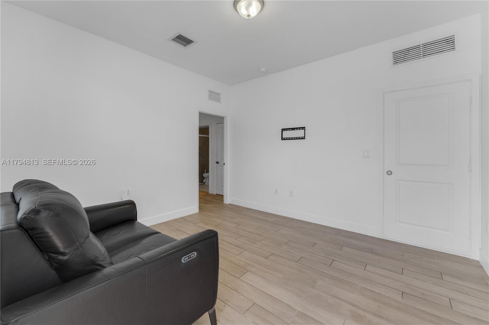 13225 Southwest 272nd Street Homestead, FL 33032 - Photo 29 of 44 a living room with furniture and a wooden floor