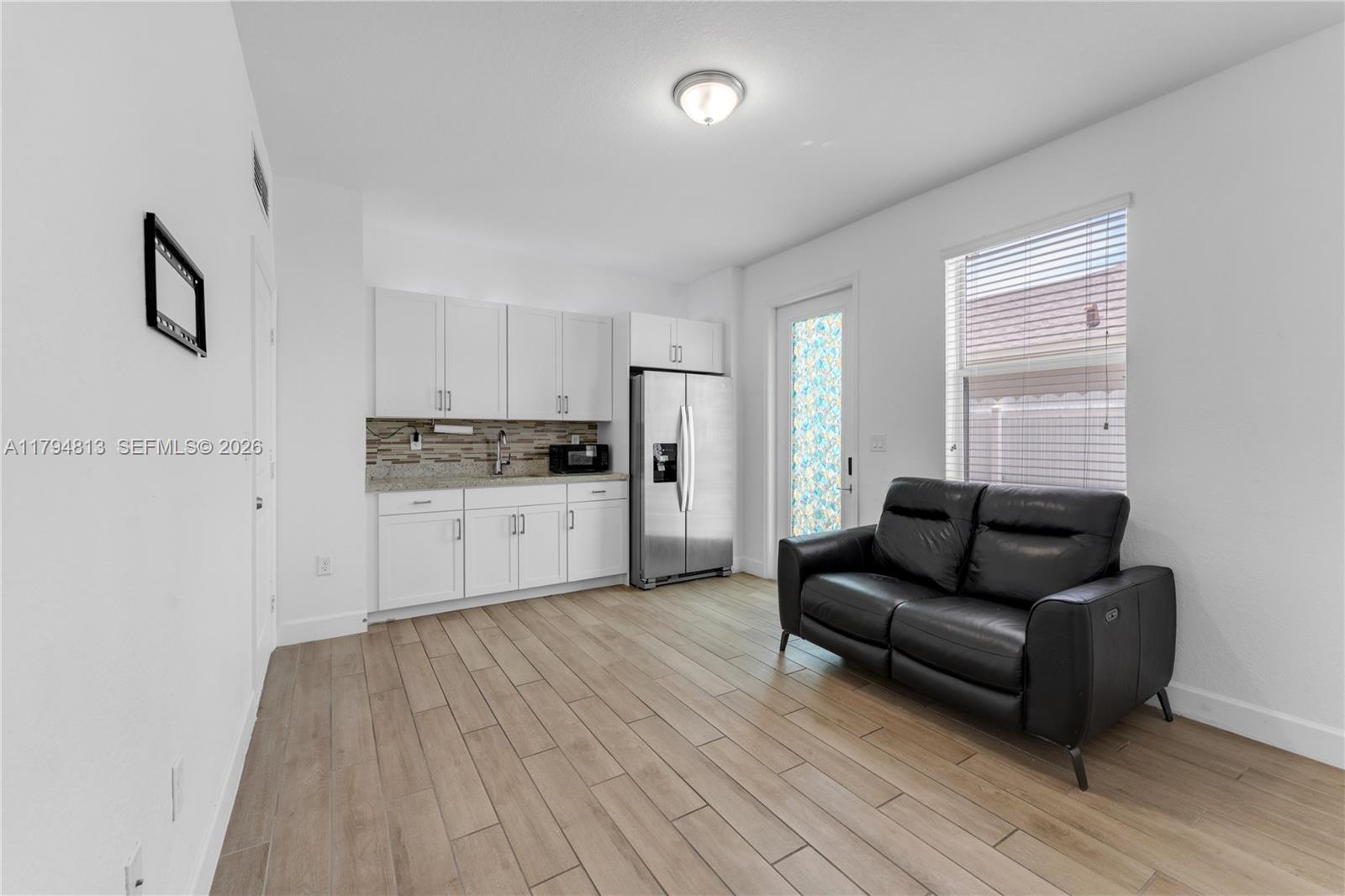 13225 Southwest 272nd Street Homestead, FL 33032 - Photo 30 of 44 a living room with furniture and a wooden floor