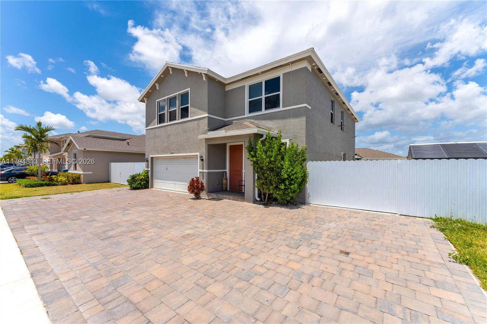 13225 Southwest 272nd Street Homestead, FL 33032 - Photo 3 of 44 a front view of a house with a yard and garage