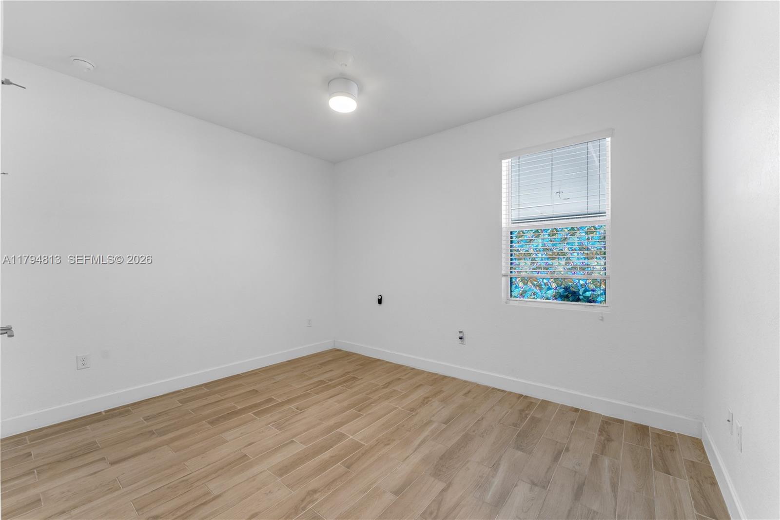 13225 Southwest 272nd Street Homestead, FL 33032 - Photo 31 of 44 wooden floor in an empty room with a window