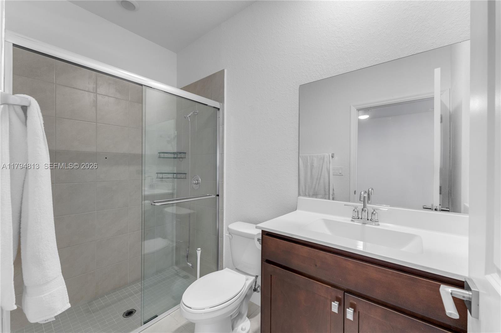 13225 Southwest 272nd Street Homestead, FL 33032 - Photo 32 of 44 a bathroom with a sink a toilet and shower