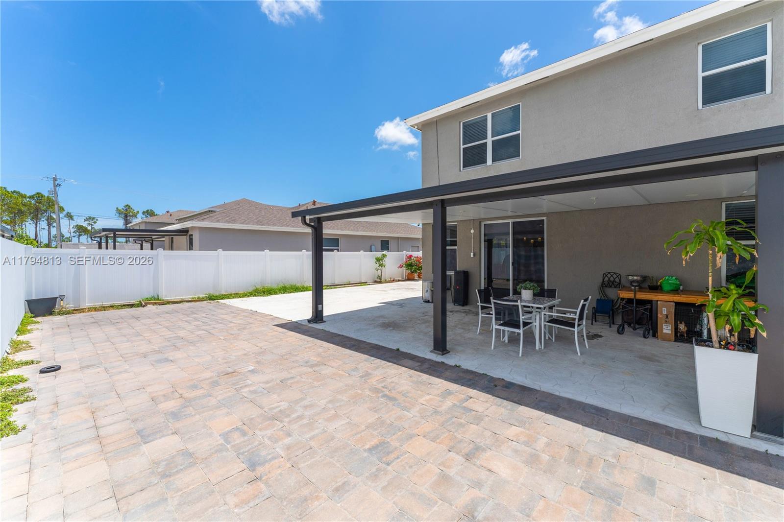 13225 Southwest 272nd Street Homestead, FL 33032 - Photo 34 of 44 a view of a patio with table and chairs with wooden floor and fence