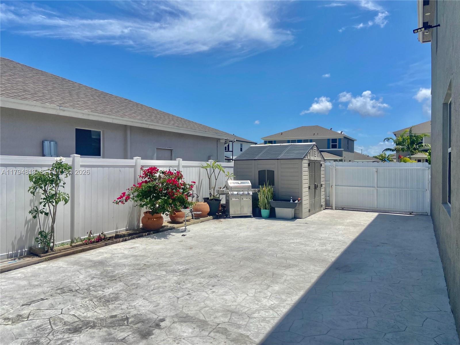 13225 Southwest 272nd Street Homestead, FL 33032 - Photo 39 of 44 a view of a house with a patio