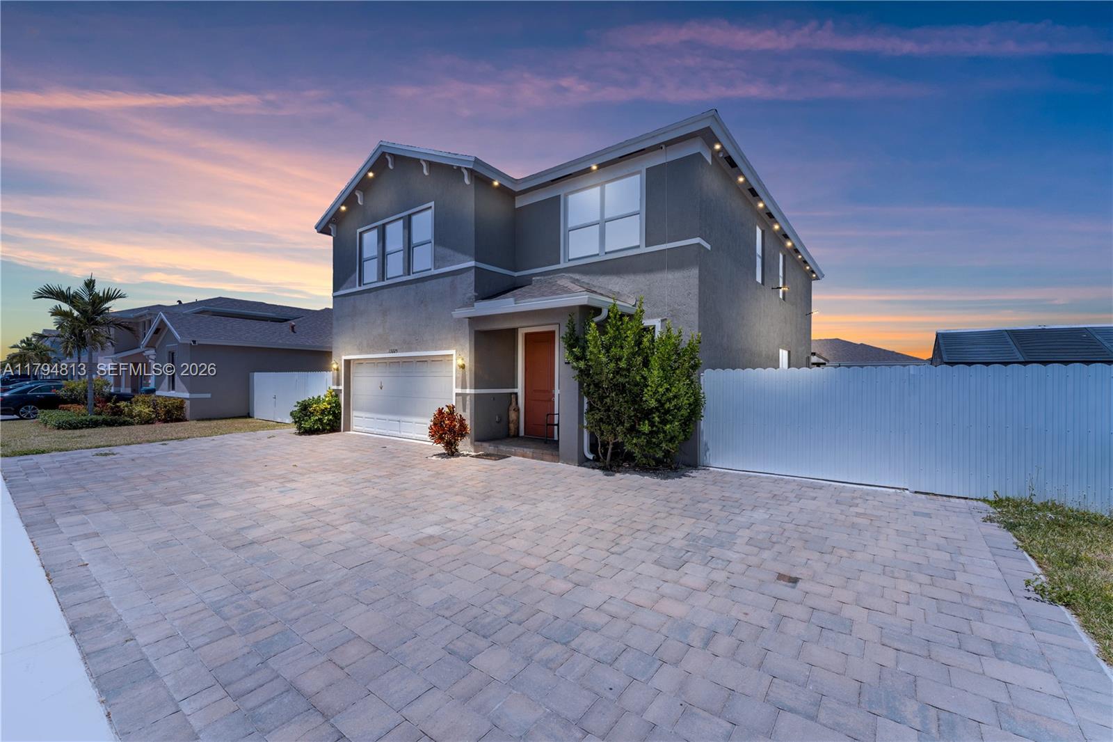 13225 Southwest 272nd Street Homestead, FL 33032 - Photo 4 of 44 a front view of a house with a yard and garage