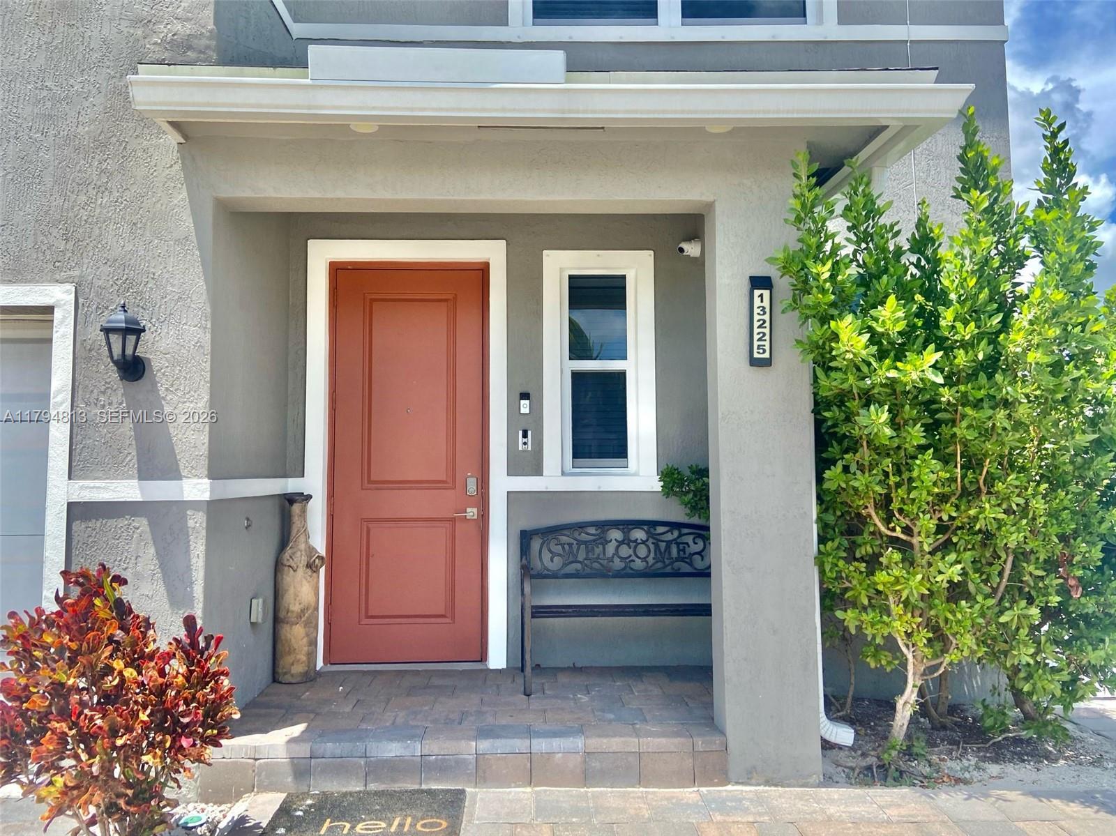 13225 Southwest 272nd Street Homestead, FL 33032 - Photo 5 of 44 a front view of a house with a garden