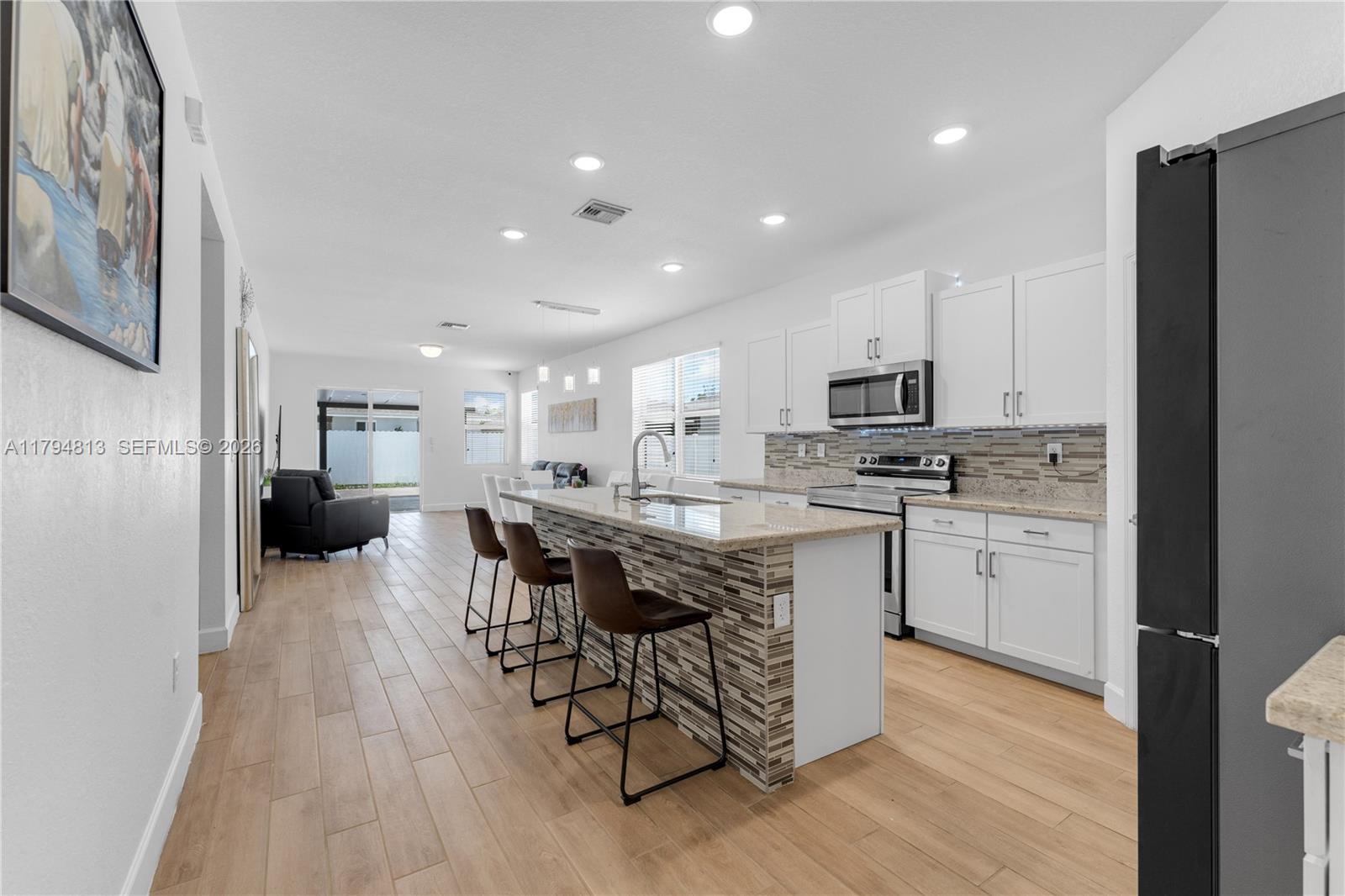 13225 Southwest 272nd Street Homestead, FL 33032 - Photo 6 of 44 a kitchen with a sink a counter top space stainless steel appliances and cabinets