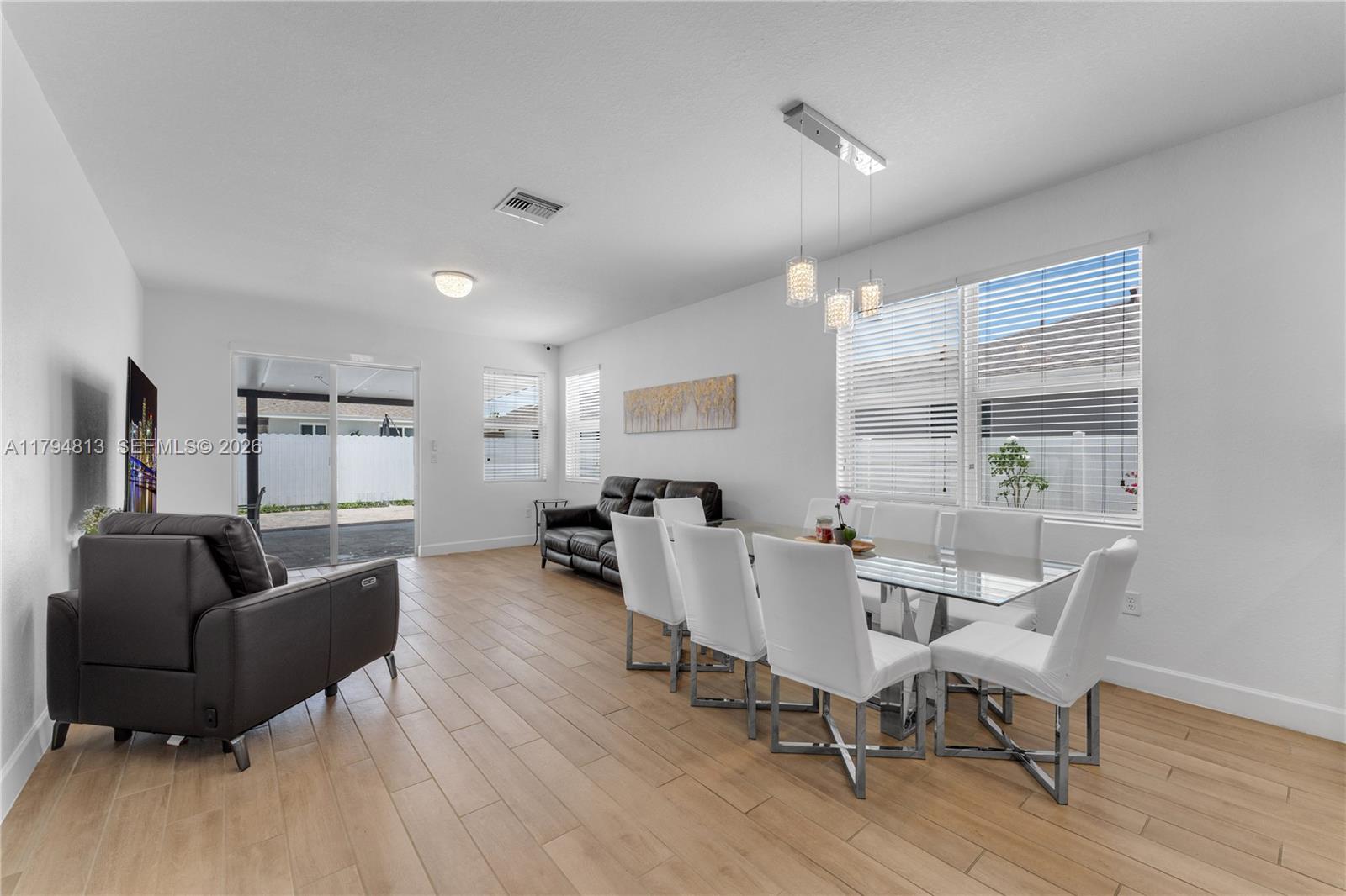 13225 Southwest 272nd Street Homestead, FL 33032 - Photo 8 of 44 a living room with furniture and a large window