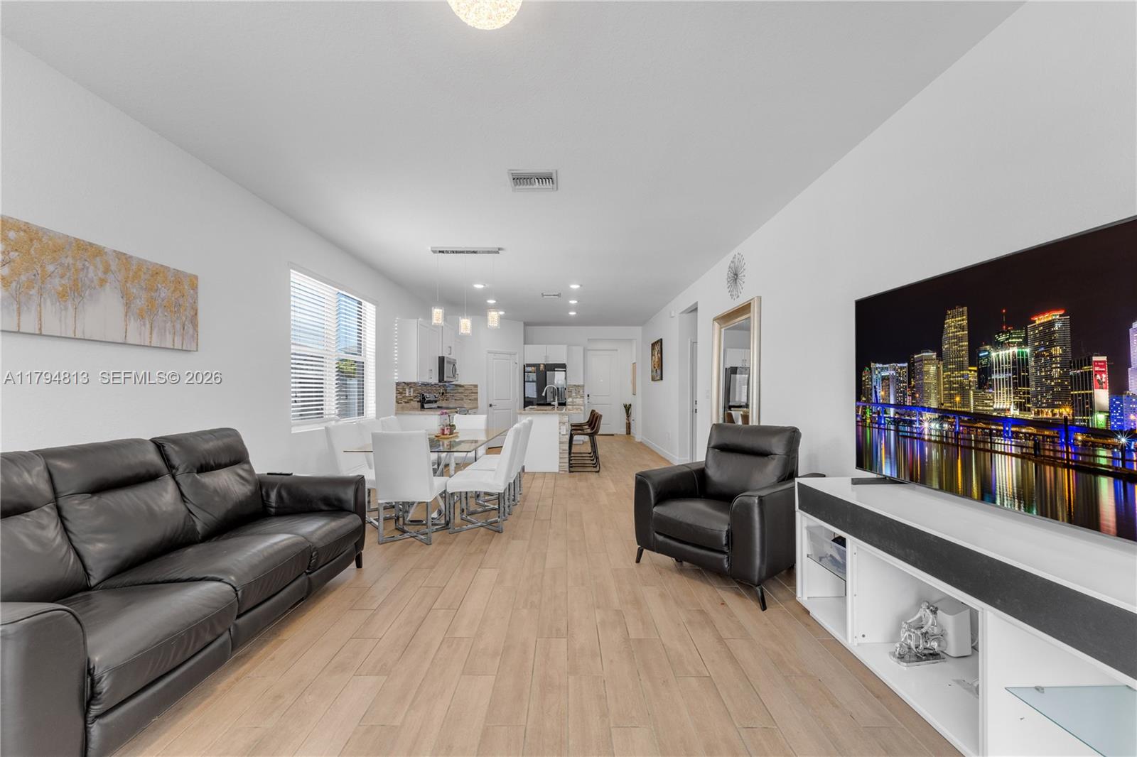 13225 Southwest 272nd Street Homestead, FL 33032 - Photo 9 of 44 a living room with furniture and a flat screen tv